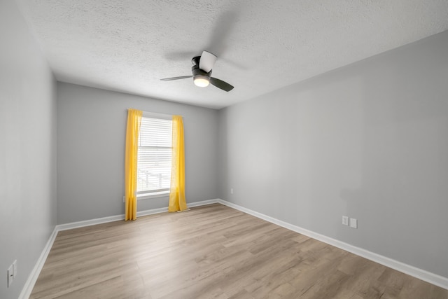 unfurnished room with ceiling fan, light hardwood / wood-style floors, and a textured ceiling