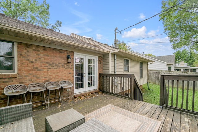 deck featuring french doors and a yard