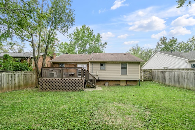 back of house with a yard and a deck