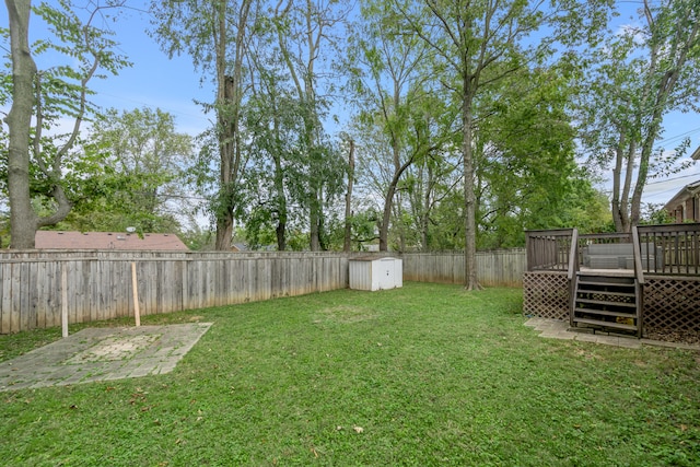 view of yard with a deck and a shed