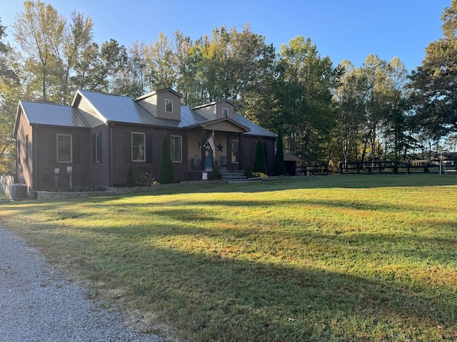 view of front of property featuring central air condition unit and a front yard