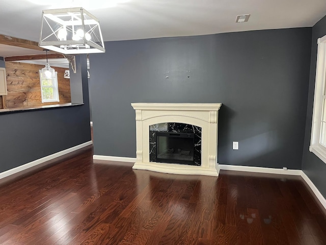 unfurnished living room with hardwood / wood-style floors, beam ceiling, and a fireplace