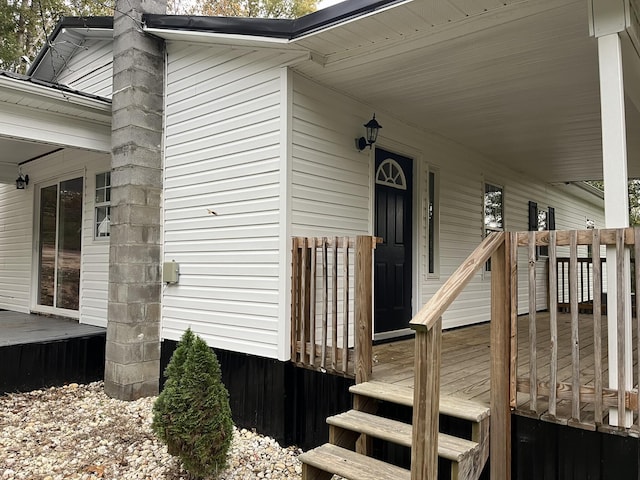 property entrance featuring a wooden deck