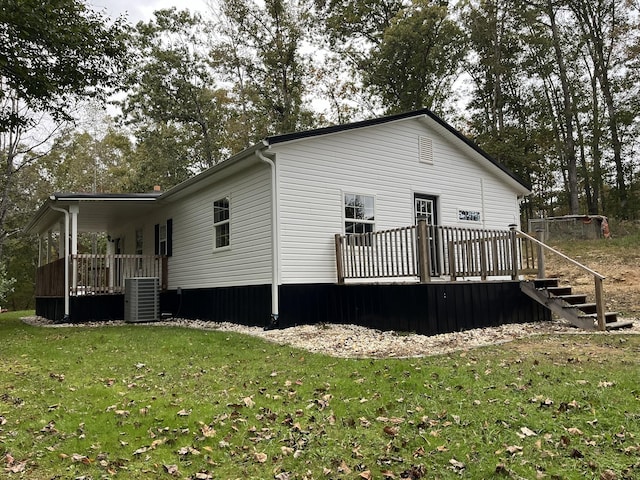 view of property exterior featuring a yard, cooling unit, and a deck