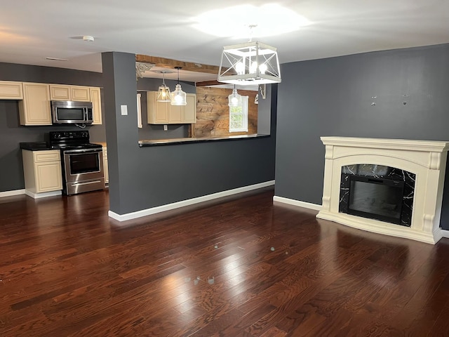 unfurnished living room with a fireplace, dark wood-style floors, and baseboards