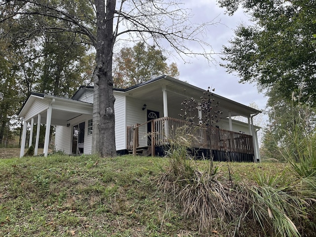 exterior space with a chimney and a porch