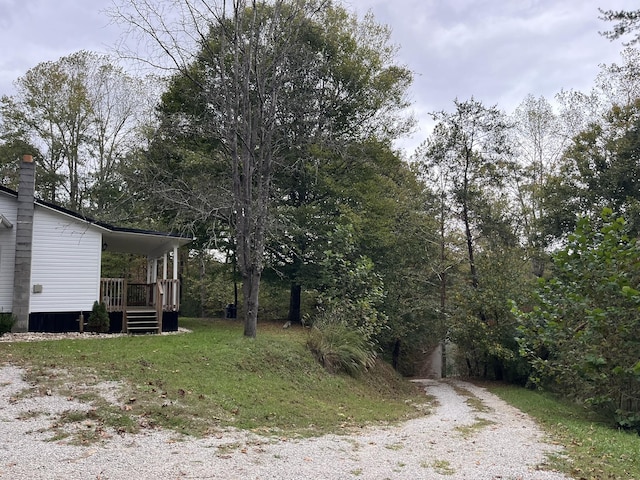 view of yard with covered porch and driveway