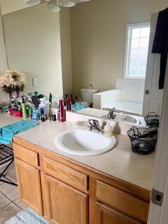 bathroom with tile patterned floors, toilet, and vanity