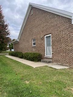 view of property exterior with a yard