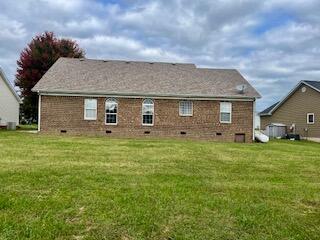 rear view of house with a lawn