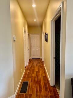 hall with dark wood-type flooring