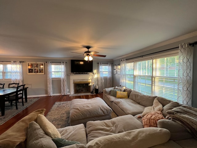 living room featuring a wealth of natural light, ceiling fan, ornamental molding, and hardwood / wood-style flooring