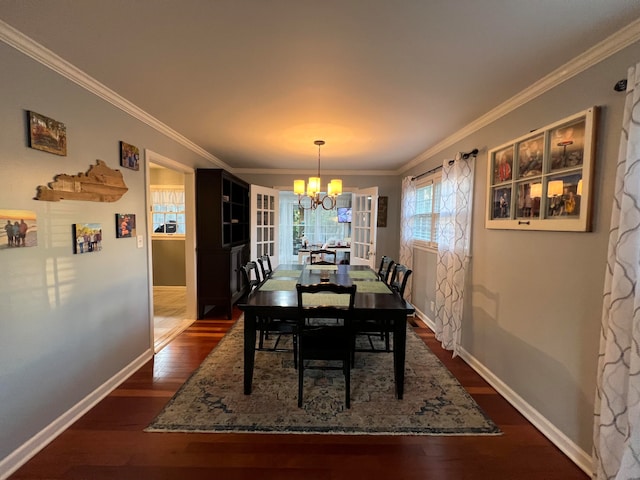 dining room featuring dark hardwood / wood-style flooring, crown molding, and a chandelier