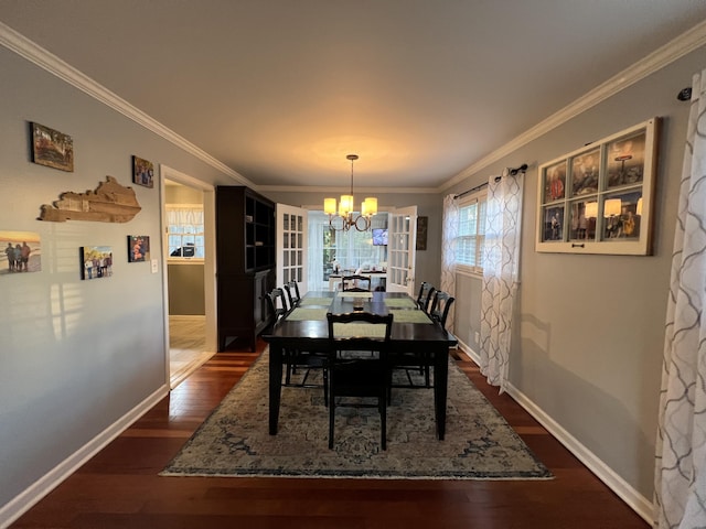 dining area featuring a chandelier, dark wood finished floors, baseboards, and ornamental molding