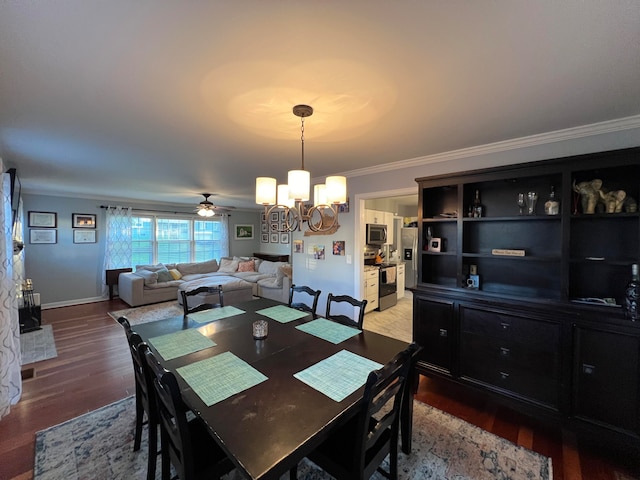 dining room featuring ceiling fan with notable chandelier, crown molding, and dark wood-type flooring