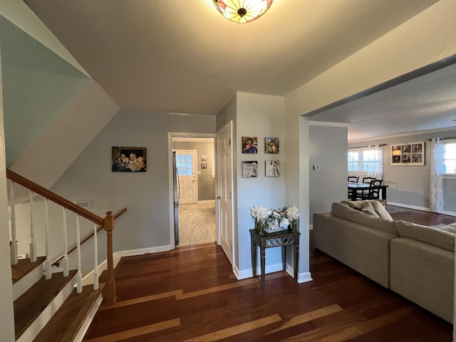 hall with baseboards, wood finished floors, and stairs