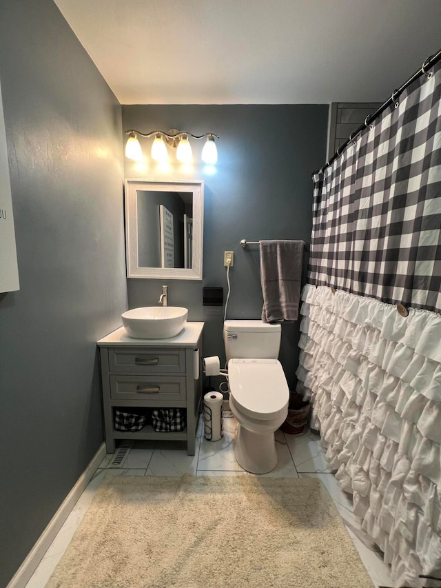 bathroom with tile patterned floors, vanity, toilet, and a shower with curtain