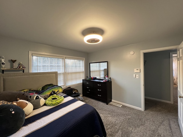 carpeted bedroom with baseboards