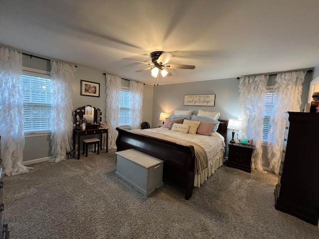 bedroom with ceiling fan and dark carpet