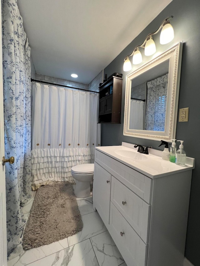 bathroom featuring vanity, curtained shower, and toilet