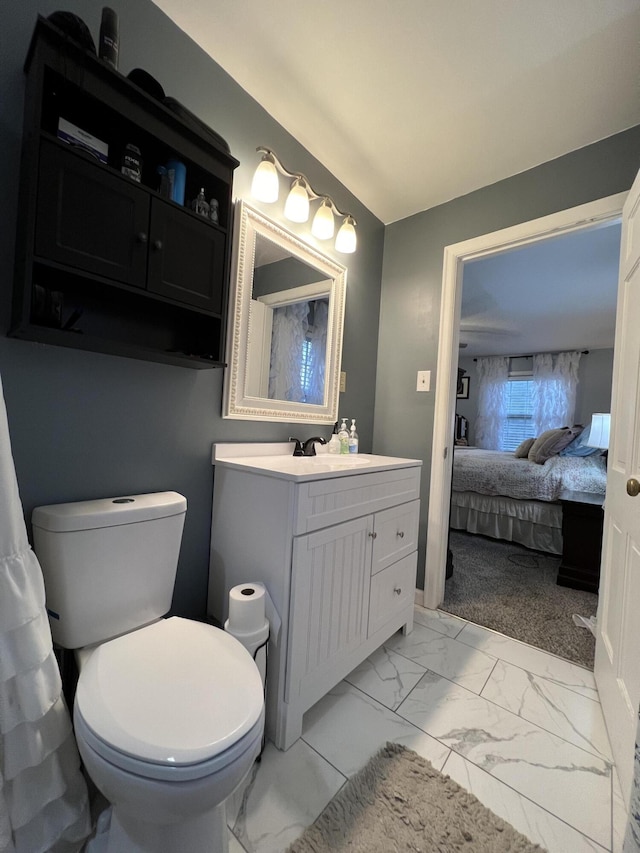 bathroom with ensuite bath, marble finish floor, vanity, and toilet