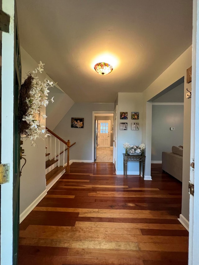 foyer featuring dark hardwood / wood-style flooring and vaulted ceiling