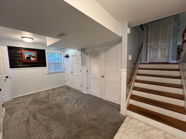 basement featuring light colored carpet