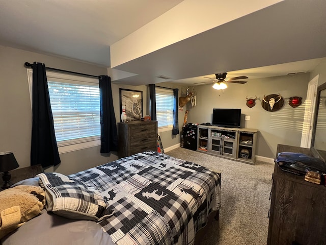 bedroom featuring carpet flooring, multiple windows, and ceiling fan