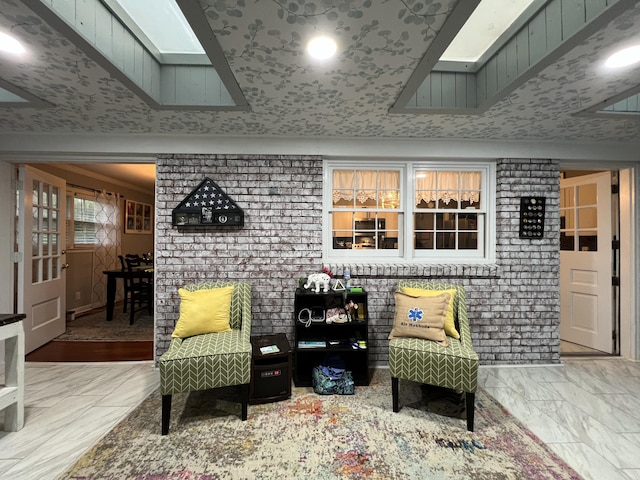 living area with marble finish floor and a skylight