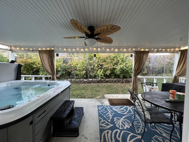 view of patio / terrace featuring a ceiling fan, outdoor dining area, and a hot tub