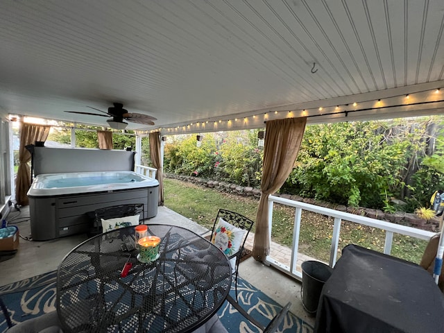 view of patio / terrace featuring ceiling fan and a hot tub