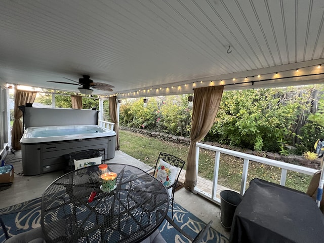 exterior space featuring outdoor dining area, a patio area, a hot tub, and a ceiling fan