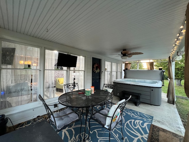 view of patio / terrace with ceiling fan and a hot tub