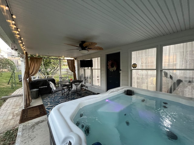 view of patio / terrace featuring a hot tub and ceiling fan