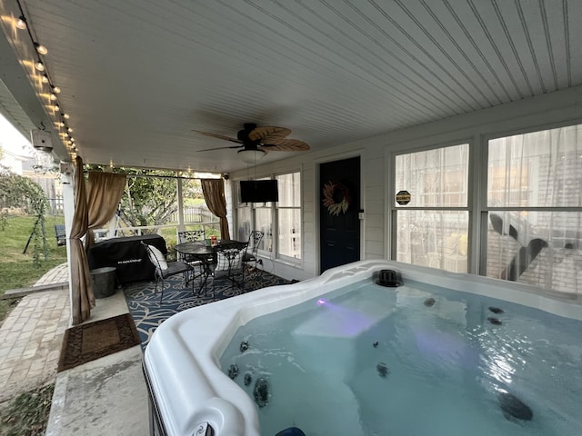 view of patio / terrace featuring a ceiling fan, a hot tub, outdoor dining area, and fence