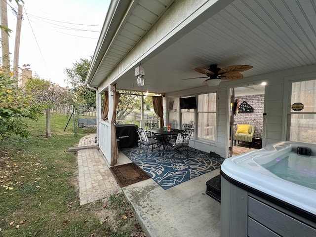 view of patio / terrace featuring a hot tub and ceiling fan