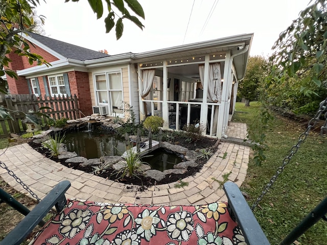 rear view of property with cooling unit