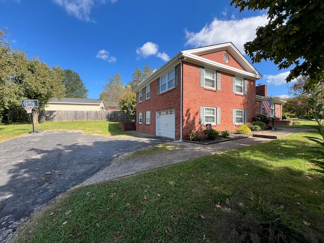 view of side of home featuring a garage and a lawn