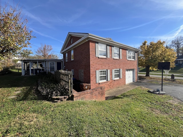 view of side of home featuring a yard and a garage