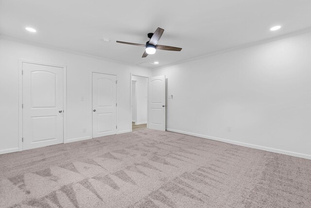 unfurnished bedroom featuring ornamental molding, carpet flooring, and ceiling fan