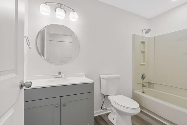 full bathroom with vanity, shower / washtub combination, hardwood / wood-style floors, and toilet