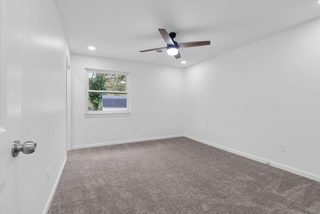 spare room with carpet floors and ceiling fan