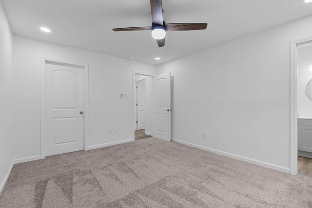 unfurnished bedroom featuring light colored carpet and ceiling fan