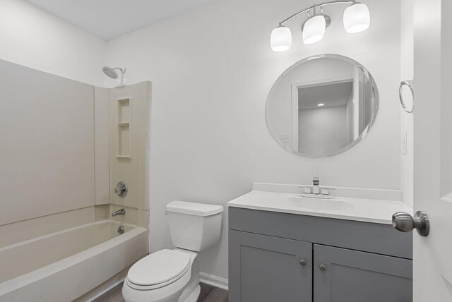 full bathroom with toilet, hardwood / wood-style flooring, vanity, and bathing tub / shower combination