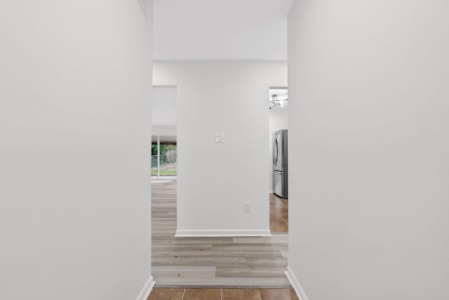 corridor with light hardwood / wood-style flooring