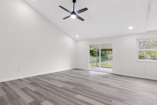 unfurnished room featuring ceiling fan, high vaulted ceiling, and light hardwood / wood-style flooring