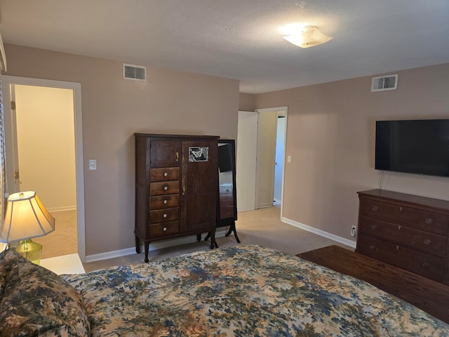 carpeted bedroom with a textured ceiling