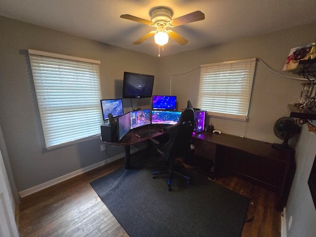 office space with dark wood-type flooring, a healthy amount of sunlight, and ceiling fan