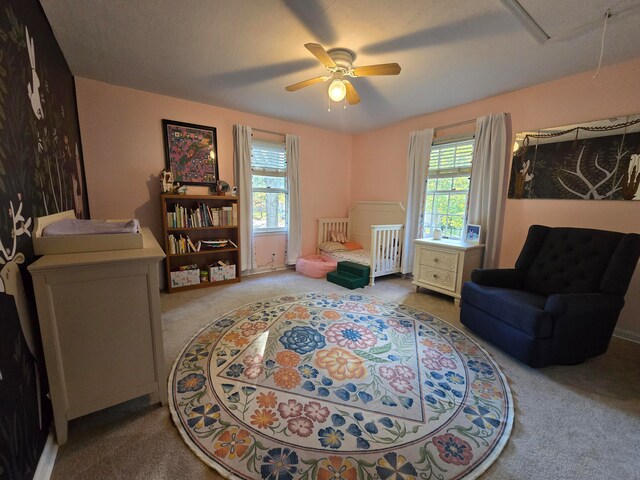 sitting room with carpet flooring and ceiling fan