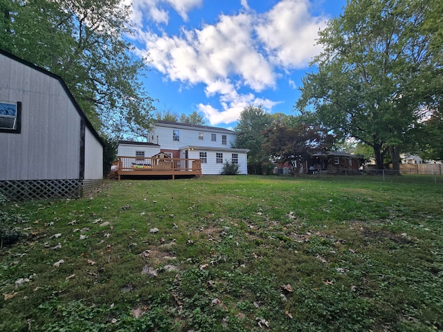 view of yard featuring a deck and an outbuilding